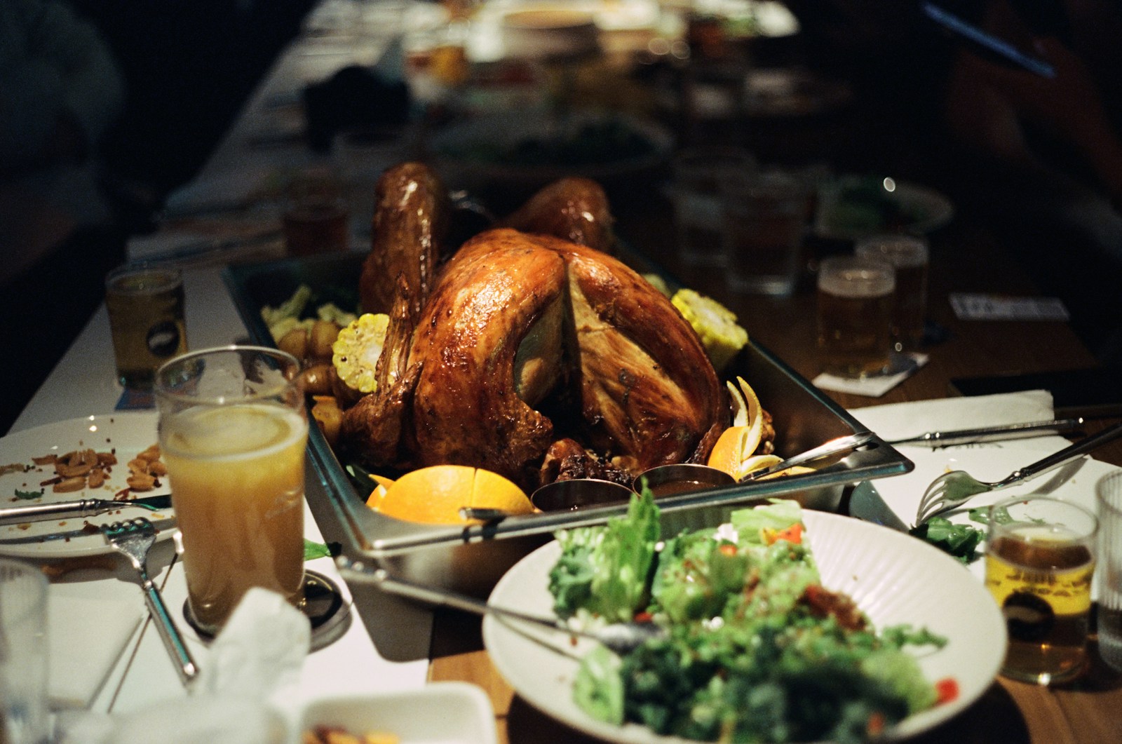 A table filled with plates of food and a turkey